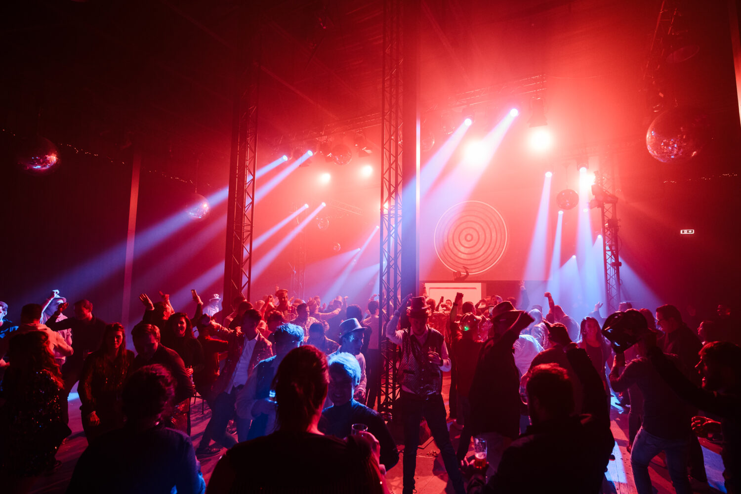 Dancing crowd under red light.